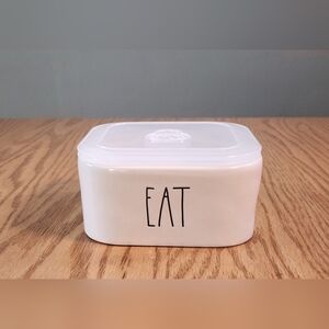Rae Dunn "EAT" ceramic food storage container with a vented plastic lid